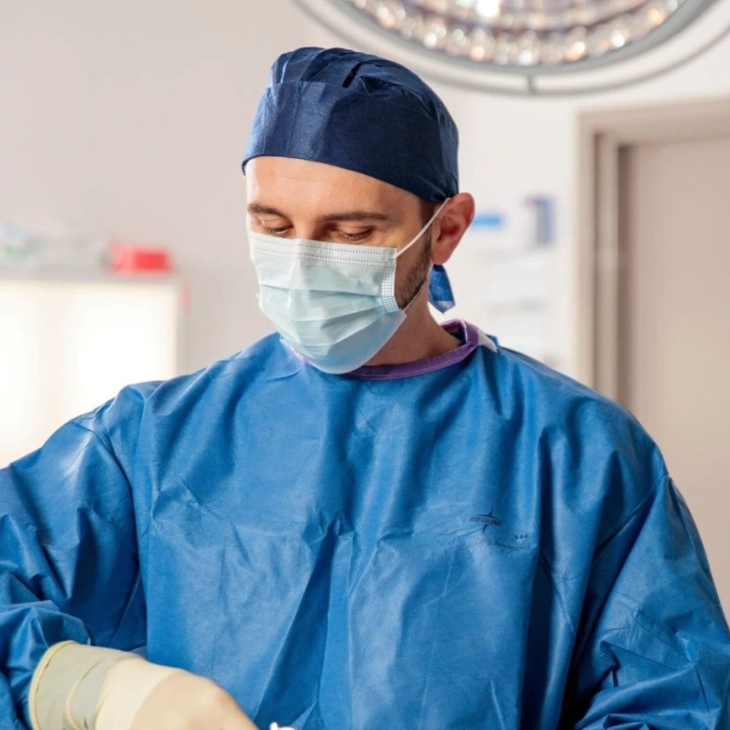 Dr Alexey Borshch, foot and ankle surgeon in Brisbane, gowned and masked in the operating theatre