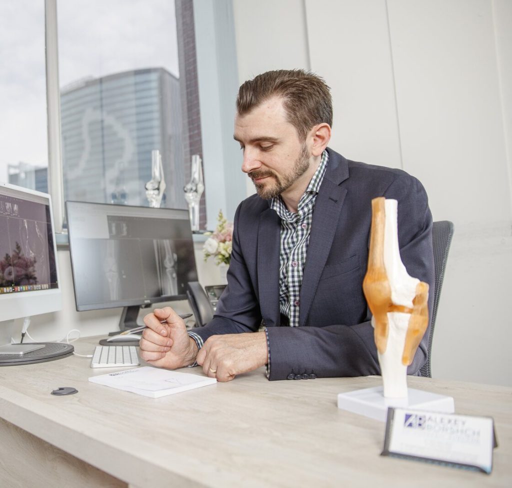 Dr Alexey Borshch in consultation with a patient