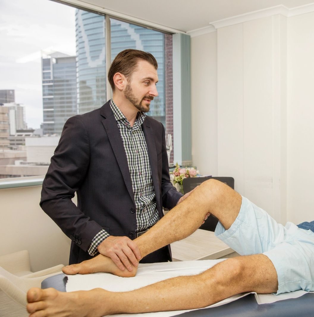 Minced cartilage autograft: Dr Alexey Borshch examining a patient's knee during a consultation